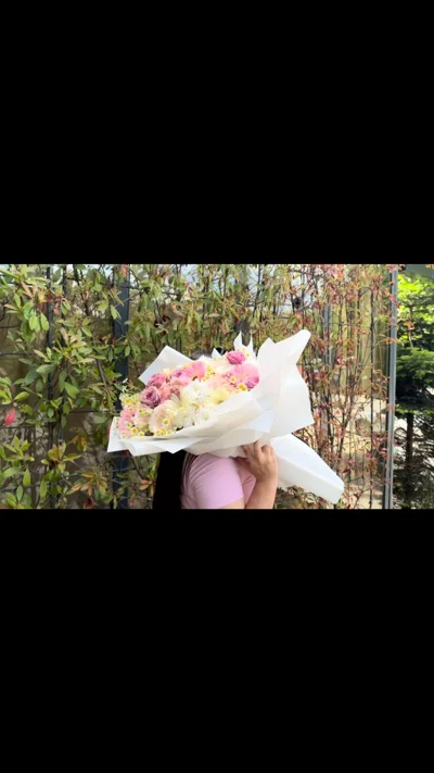 Buqetë me lule pastel në letër të bardhë