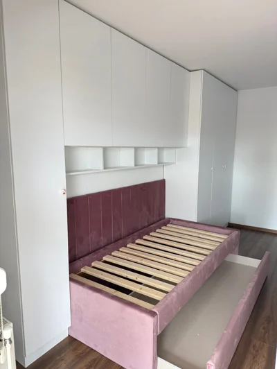 Shtrat rozë me sirtar dhe dollap mbi shtrat