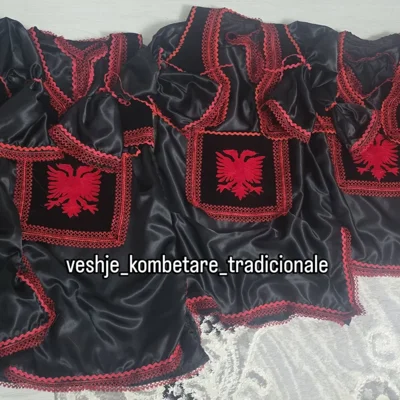 Jelekë të zi me shqiponjë dhe zbukurime të kuqe